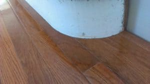A wooden floor with a white bowl on top of it.